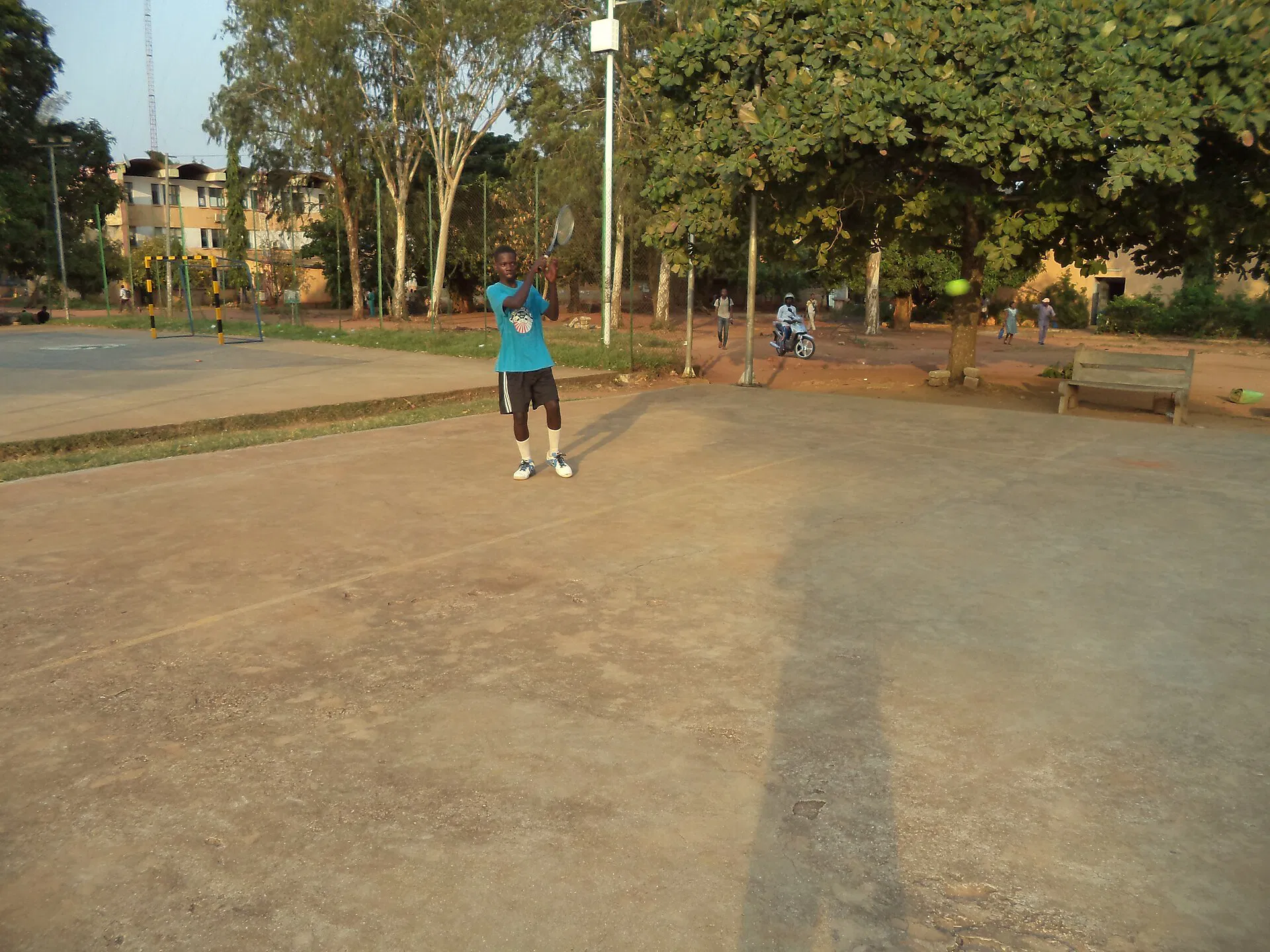 Tennis players rallying on an outdoor hard court